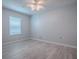 Bedroom features light-colored wood floors, natural light, and a ceiling fan at 1016 Eagles Lndg, Leesburg, FL 34748