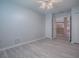 Bedroom with light-colored wood floors, closet, and view to kitchen at 1016 Eagles Lndg, Leesburg, FL 34748