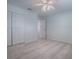 Light bedroom showcases a ceiling fan, carpet flooring, and closet space at 1016 Eagles Lndg, Leesburg, FL 34748