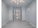 Bedroom featuring light-colored wood floors, double closets, and view into kitchen at 1016 Eagles Lndg, Leesburg, FL 34748