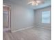 Bedroom with light-colored wood floors, window, and view to living spaces at 1016 Eagles Lndg, Leesburg, FL 34748