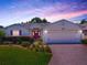 Charming single-story home with a well-manicured lawn, beautiful landscaping, and a brick-paved driveway at 1016 Eagles Lndg, Leesburg, FL 34748