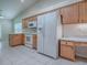 Kitchen with tile flooring, a window, and wood cabinets at 1016 Eagles Lndg, Leesburg, FL 34748