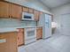 Kitchen featuring wood cabinets and white appliances at 1016 Eagles Lndg, Leesburg, FL 34748