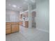Open-concept kitchen with tile flooring, wood cabinets, and white countertops at 1016 Eagles Lndg, Leesburg, FL 34748