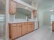 Kitchen area featuring wood cabinets, white counters, and tile flooring at 1016 Eagles Lndg, Leesburg, FL 34748
