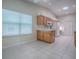 Kitchen with white tile flooring and appliances, wood cabinetry and countertops at 1016 Eagles Lndg, Leesburg, FL 34748