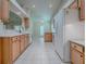 Spacious kitchen with tile flooring, wooden cabinets, and modern appliances at 1016 Eagles Lndg, Leesburg, FL 34748