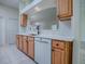 Kitchen area featuring wood cabinets, a white countertop, and tile flooring at 1016 Eagles Lndg, Leesburg, FL 34748