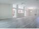 Open floor plan with light-colored wood floors and views into the kitchen and other living spaces at 1016 Eagles Lndg, Leesburg, FL 34748