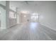 Bright, open-concept living room with light-colored wood floors and views of the kitchen and entry at 1016 Eagles Lndg, Leesburg, FL 34748