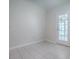 Bright living room boasts tile floors and direct access to the outdoors at 1016 Eagles Lndg, Leesburg, FL 34748