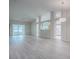 Open-concept living room with wood-look flooring, neutral walls, and an open view of the kitchen at 1016 Eagles Lndg, Leesburg, FL 34748