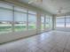 Sunroom featuring tile flooring, ceiling fans, and multiple windows offering plenty of natural light at 1016 Eagles Lndg, Leesburg, FL 34748