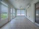 Bright sunroom featuring tile flooring, ceiling fans, and multiple windows with outdoor views at 1016 Eagles Lndg, Leesburg, FL 34748