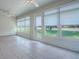 Well-lit sunroom featuring tile flooring, ceiling fans, and a door leading to the backyard at 1016 Eagles Lndg, Leesburg, FL 34748