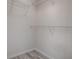 Bright walk-in closet with white walls, neutral flooring, and built-in wire shelving at 1016 Eagles Lndg, Leesburg, FL 34748