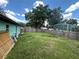 Fenced backyard featuring a lush green lawn, providing privacy and security for outdoor enjoyment at 102 Harold St, Leesburg, FL 34748