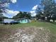 Expansive backyard with a well-maintained lawn offering ample space for outdoor activities and relaxation at 102 Harold St, Leesburg, FL 34748