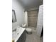 Modern bathroom features a luxurious, tiled shower, vanity, and fixtures at 102 Harold St, Leesburg, FL 34748
