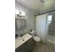 The bathroom includes a vanity with storage, updated fixtures, and a shower at 102 Harold St, Leesburg, FL 34748