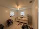 Bedroom with natural light, a ceiling fan, and tiled floors is awaiting your design touch at 102 Harold St, Leesburg, FL 34748