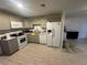 Modern kitchen featuring stainless steel appliances, sleek countertops, and ample cabinet space for storage solutions at 102 Harold St, Leesburg, FL 34748