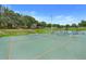 Community basketball court is surrounded by mature trees, providing a space for sports and recreation at 10301 Us Highway 27 # 187, Clermont, FL 34711