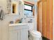Bathroom with white vanity and toilet and wood trimmed window at 10301 Us Highway 27 # 187, Clermont, FL 34711