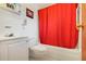 Bathroom with white fixtures and a red shower curtain at 10301 Us Highway 27 # 187, Clermont, FL 34711