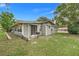 Inviting home exterior featuring neutral siding, a screened lanai, and a well-maintained lawn, creating a serene outdoor living space at 10301 Us Highway 27 # 187, Clermont, FL 34711