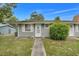 Charming home featuring a well-manicured lawn and inviting front entrance with cute cat statues at 10301 Us Highway 27 # 187, Clermont, FL 34711