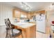 Bright kitchen with a breakfast bar and white appliances at 10301 Us Highway 27 # 187, Clermont, FL 34711