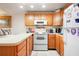 This cozy kitchen features light wood cabinets and white appliances at 10301 Us Highway 27 # 187, Clermont, FL 34711