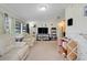 Bright living room featuring comfortable seating, neutral carpet, and a large entertainment center at 10301 Us Highway 27 # 187, Clermont, FL 34711