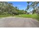 Paved parking area near lush greenery and mature trees creates a serene and welcoming atmosphere for residents and visitors alike at 10301 Us Highway 27 # 187, Clermont, FL 34711