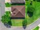 Aerial view of a well-maintained home with a brown roof and landscaped yard at 10986 Se 171St Street Rd, Summerfield, FL 34491