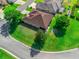 Aerial view showcasing a brown roof, screened in patio and manicured landscaping at 10986 Se 171St Street Rd, Summerfield, FL 34491
