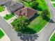 Overhead angle on a tan house with brown roof, green lawn, and mature trees on a corner lot at 10986 Se 171St Street Rd, Summerfield, FL 34491