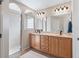 Modern bathroom with double sinks, spacious drawers, a walk-in shower and arched design at 10986 Se 171St Street Rd, Summerfield, FL 34491