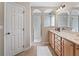 Well-lit bathroom with double sinks, spacious cabinets and a walk-in shower at 10986 Se 171St Street Rd, Summerfield, FL 34491