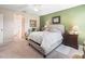 Cozy bedroom featuring an accent wall, ceiling fan and easy access to hallway at 10986 Se 171St Street Rd, Summerfield, FL 34491