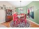 Lovely dining area with hardwood flooring, a chandelier, and a wooden table at 10986 Se 171St Street Rd, Summerfield, FL 34491