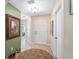 Inviting home foyer with decorative rug and neutral colored walls at 10986 Se 171St Street Rd, Summerfield, FL 34491