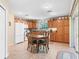 Bright eat-in kitchen features tile floors, appliances, oak cabinetry, and sliding door access to the lanai at 10986 Se 171St Street Rd, Summerfield, FL 34491