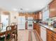 Bright eat-in kitchen showcases appliances, oak cabinetry, and overlooks the sunny back yard at 10986 Se 171St Street Rd, Summerfield, FL 34491