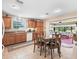 Bright eat-in kitchen features tile floors, appliances, oak cabinetry, and sliding door access to the lanai at 10986 Se 171St Street Rd, Summerfield, FL 34491