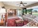 Cozy, enclosed lanai with ceiling fan, tile floors, and sliding doors to the kitchen at 10986 Se 171St Street Rd, Summerfield, FL 34491