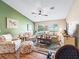 Inviting living room with vaulted ceilings, ceiling fan and large windows offers lots of natural light at 10986 Se 171St Street Rd, Summerfield, FL 34491