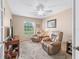 Cozy sitting room filled with comfy leather chairs and a bright window at 10986 Se 171St Street Rd, Summerfield, FL 34491